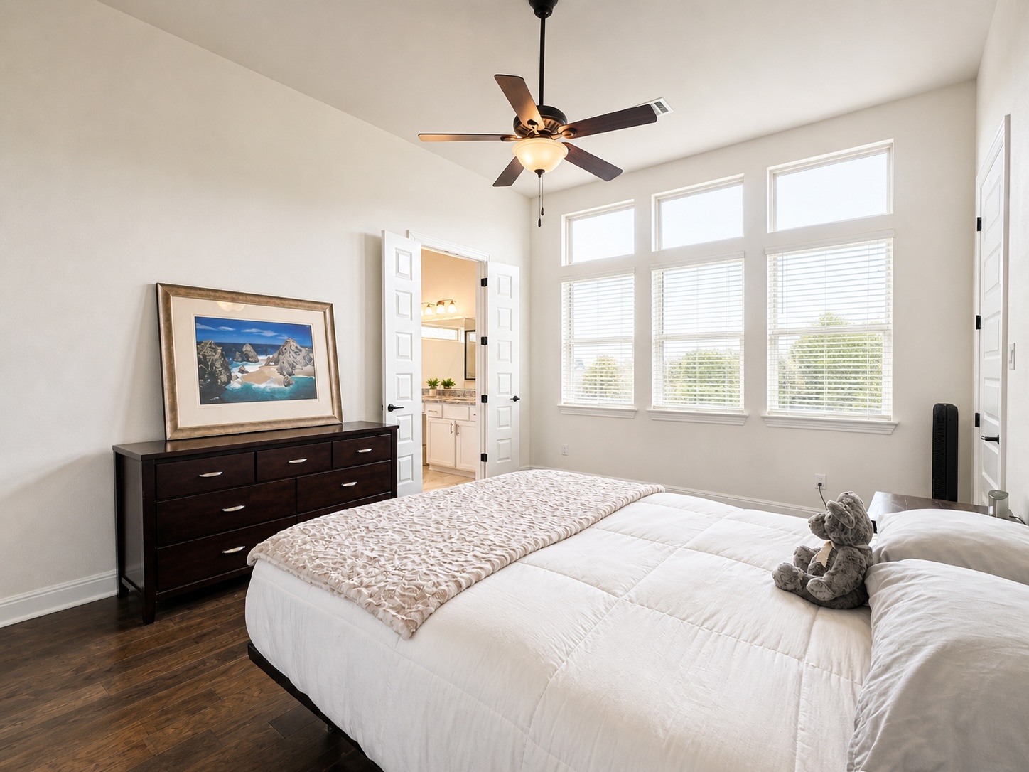 209 Rainier Drive Kyle, TX 78640 - Photo 9 of 24 Spacious room featuring wood-finish flooring, a ceiling fan with integrated lighting, and multiple large windows with blinds