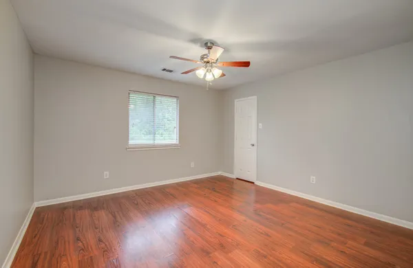 wooden floor in an empty room with a window