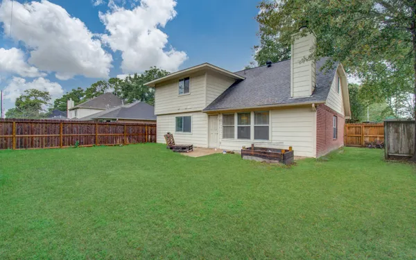 a backyard of a house with table and chairs
