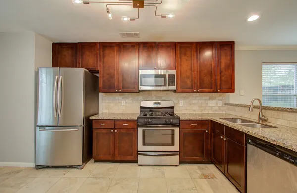 a kitchen with a sink and a refrigerator