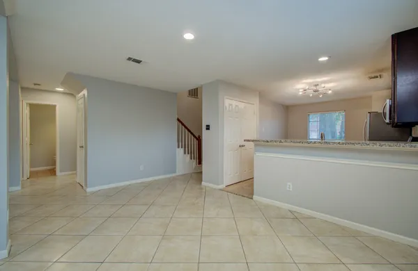 a view of a kitchen with an empty space and a window