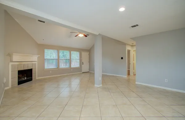 a view of an empty room with a fireplace