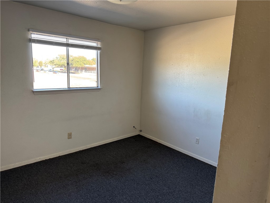 1555 Stacey Street, Unit 6 Navasota, TX 77868 - Photo 7 of 10 an empty room with a window