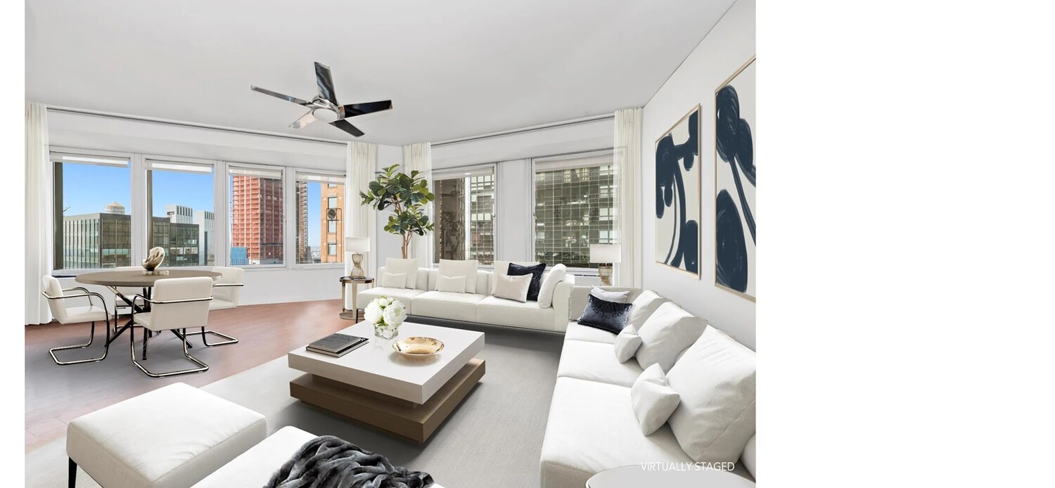 150 West 56th Street, Unit 4003 Manhattan, NY 10019 - Photo 2 of 11 a living room with furniture and a large window