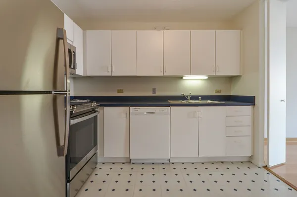 a kitchen with a refrigerator and cabinets