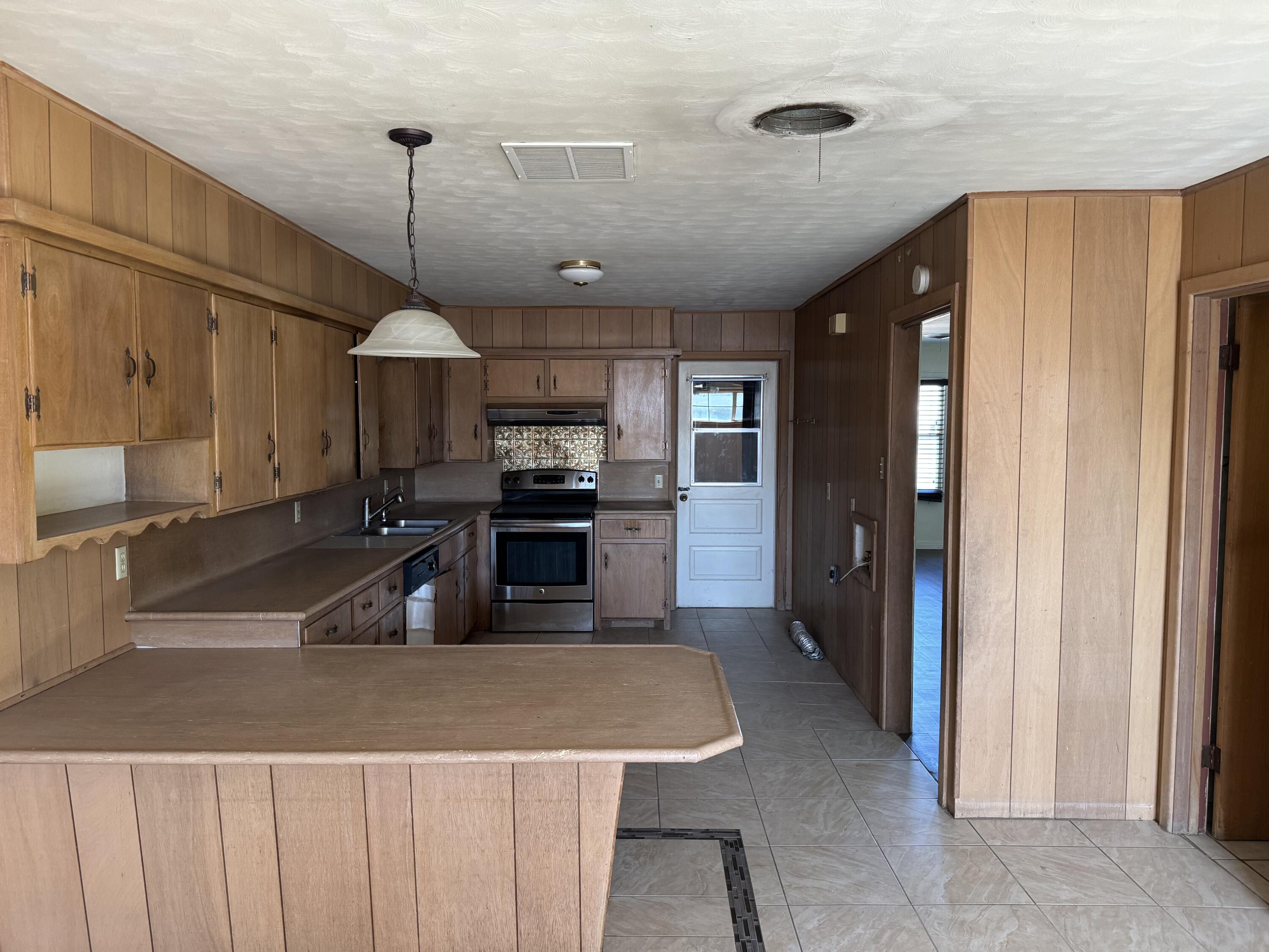 3103 Harvard Street Lubbock, TX 79415 - Photo 11 of 16 a kitchen with stainless steel appliances a sink a counter space and cabinets