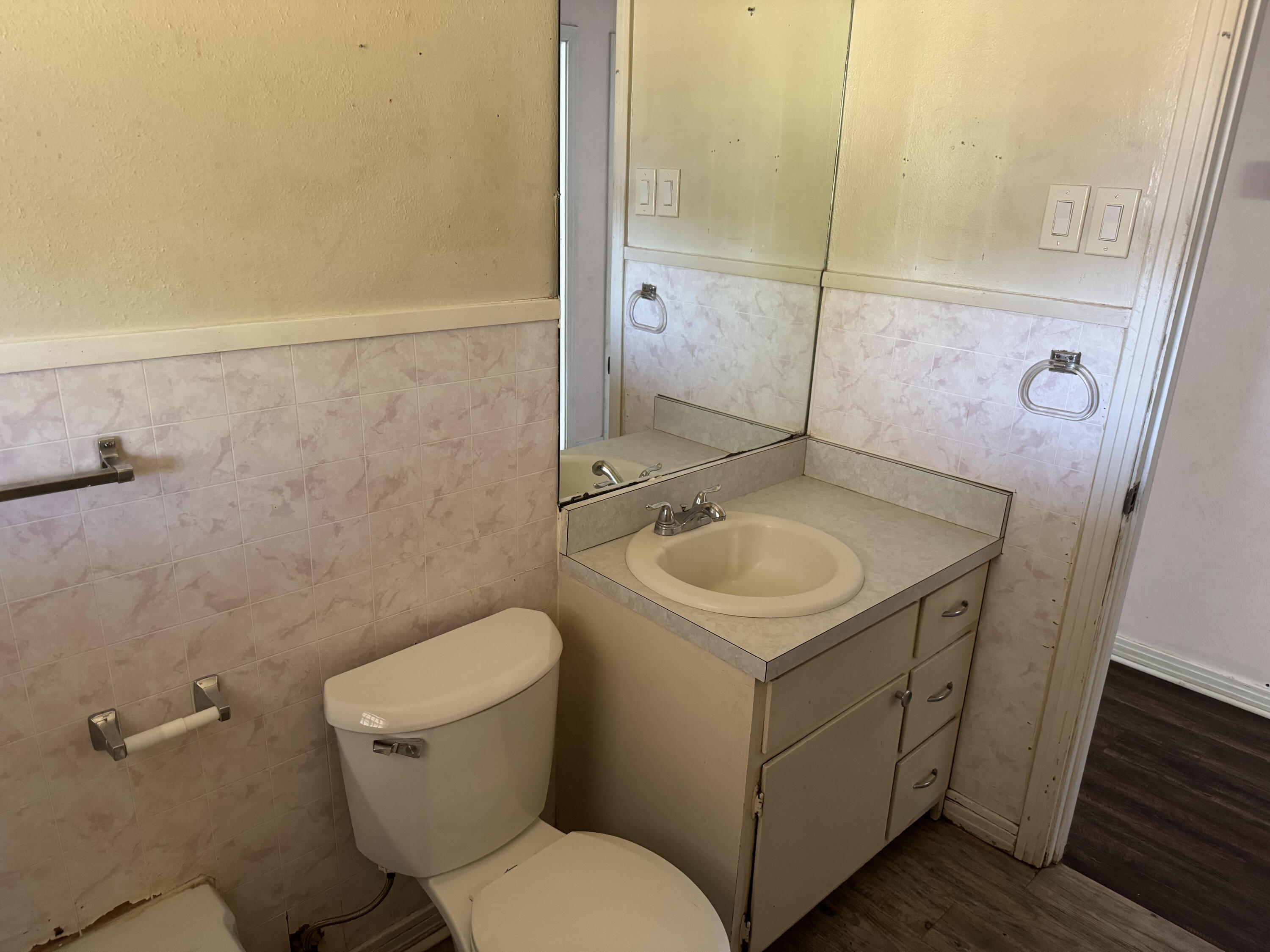 3103 Harvard Street Lubbock, TX 79415 - Photo 5 of 16 a bathroom with a sink a toilet and a mirror