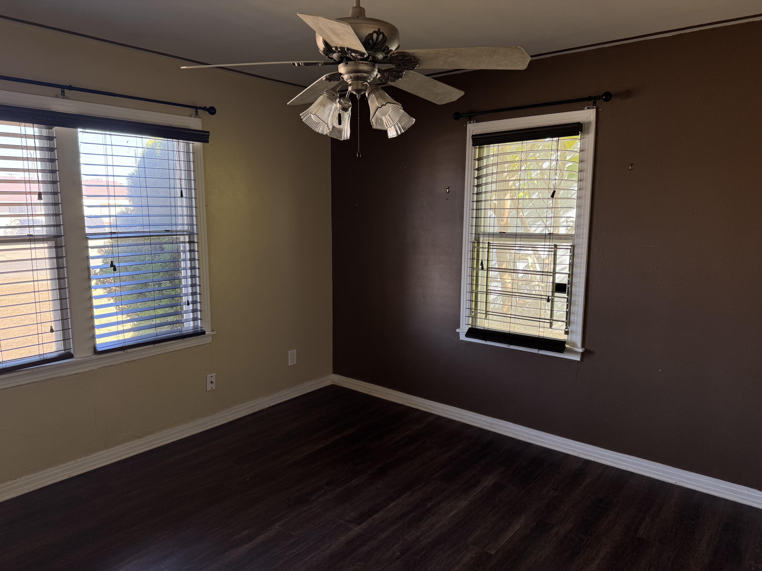 3103 Harvard Street Lubbock, TX 79415 - Photo 8 of 16 a view of an empty room with wooden floor and a window