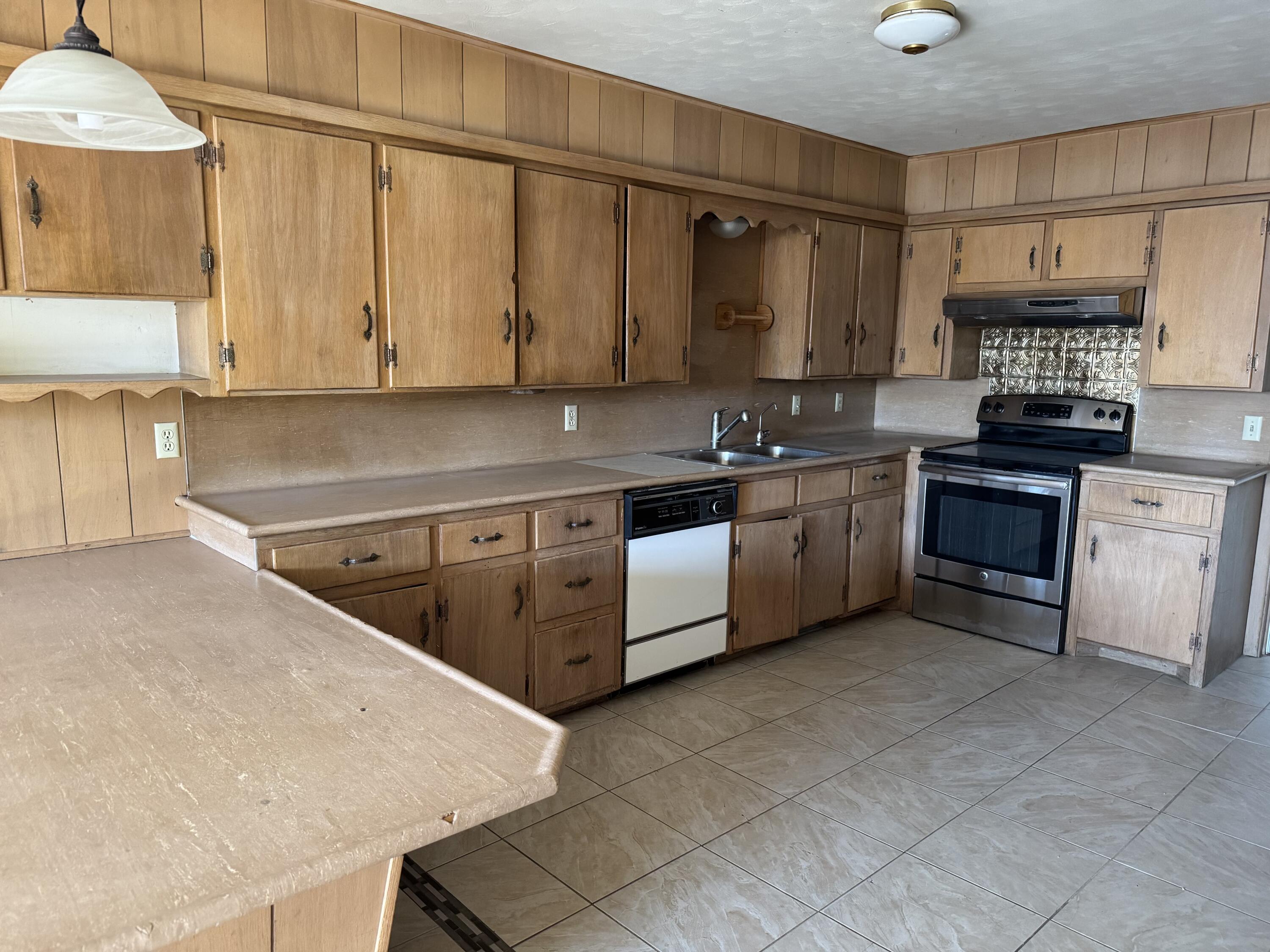3103 Harvard Street Lubbock, TX 79415 - Photo 10 of 16 a kitchen with a sink a stove and cabinets