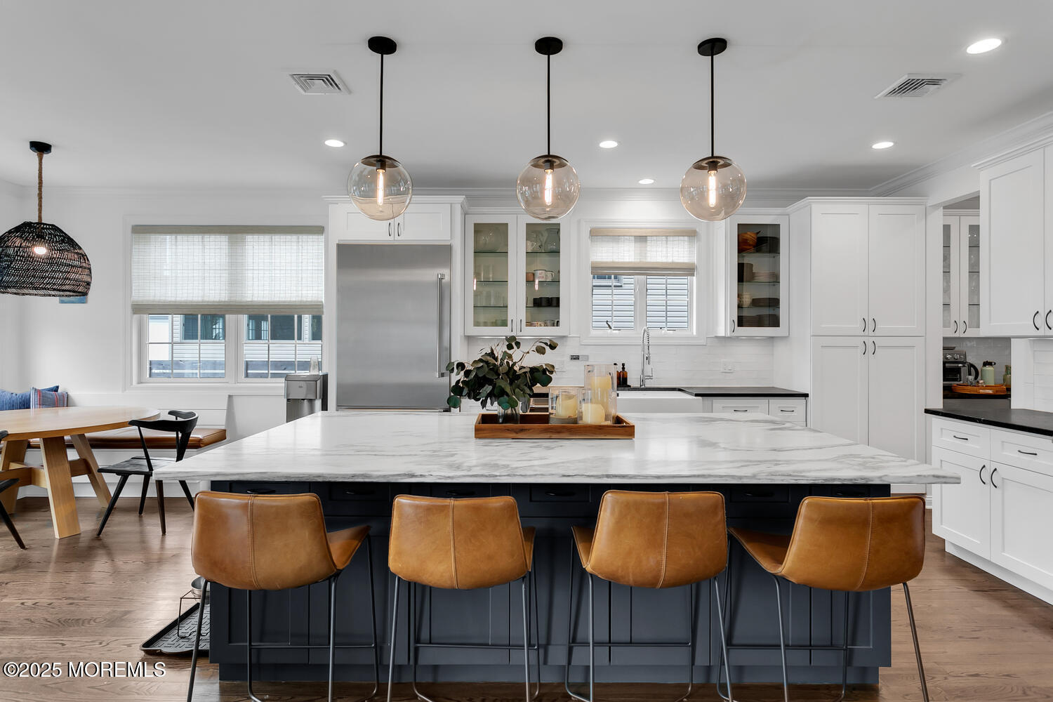 86 Washington Street Rumson, NJ 07760 - Photo 17 of 43 a kitchen with granite countertop a table chairs and white cabinets