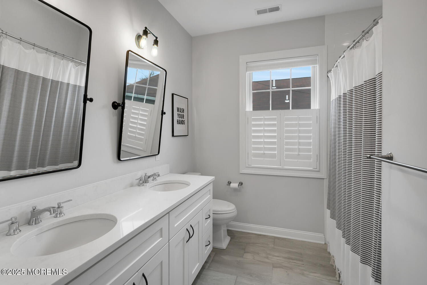 86 Washington Street Rumson, NJ 07760 - Photo 29 of 43 a bathroom with double vanity sink a mirror and a shower