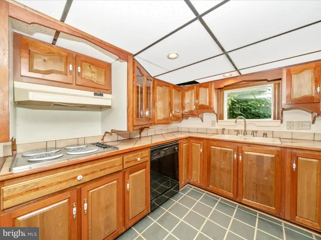 a kitchen with stainless steel appliances granite countertop a sink and cabinets