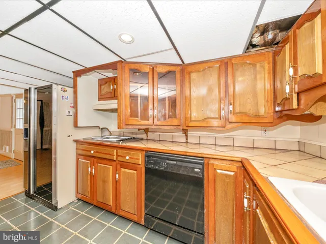 a kitchen with a sink and a refrigerator