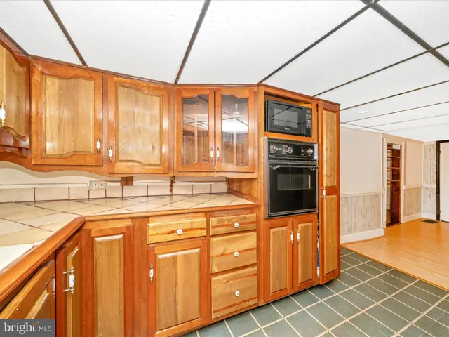 a kitchen with stainless steel appliances a sink and cabinets