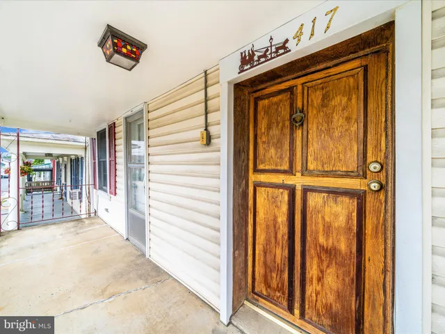 a view of a hallway with wooden floor and closet
