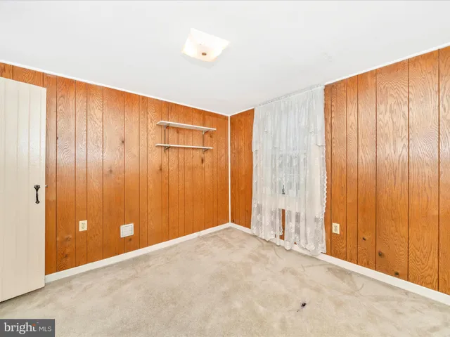 a view of a livingroom with wooden walls