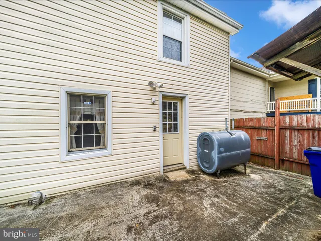 a view of a backyard with a table and chairs and potted plants