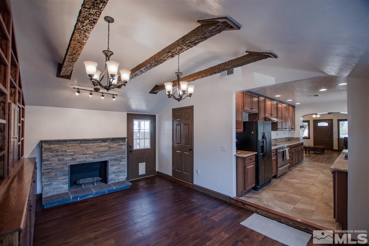 1611 Plumas Street Reno, NV 89509 - Photo 5 of 25 a view of a kitchen with a sink a refrigerator and a fireplace