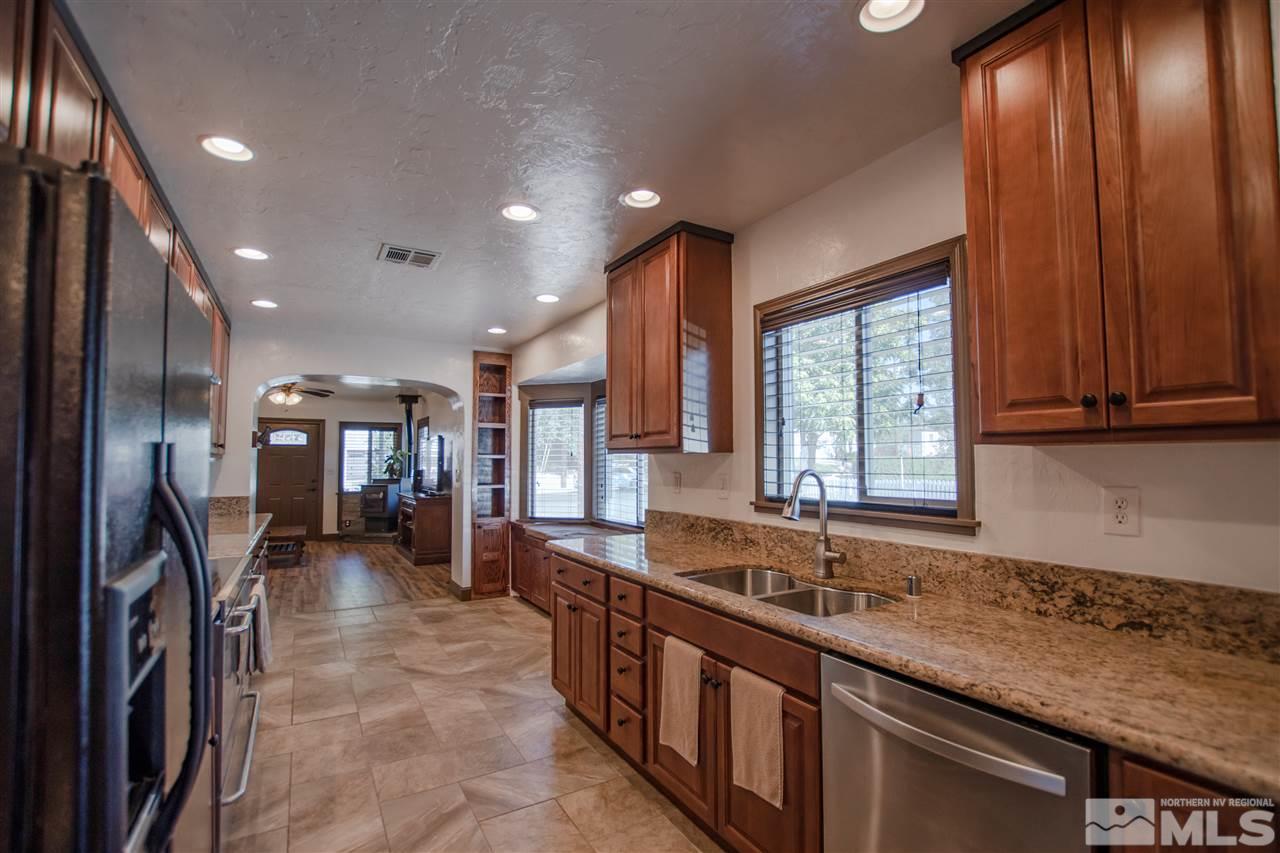 1611 Plumas Street Reno, NV 89509 - Photo 8 of 25 a large kitchen with stainless steel appliances granite countertop counter space a sink and a large window