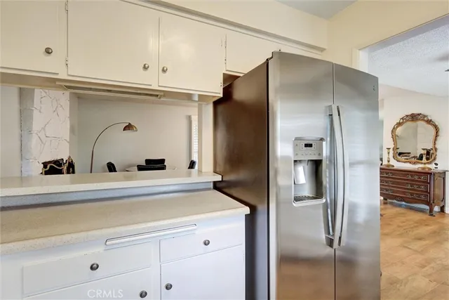 a kitchen with stainless steel appliances a refrigerator and cabinets
