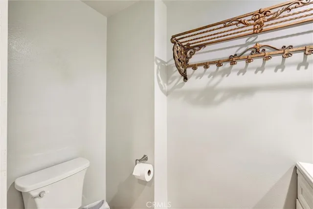 a bathroom with a toilet and a mirror