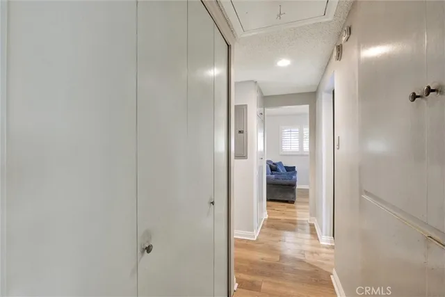 a view of a hallway with wooden shelves