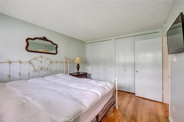 a bedroom with a bed and a painting on the wall