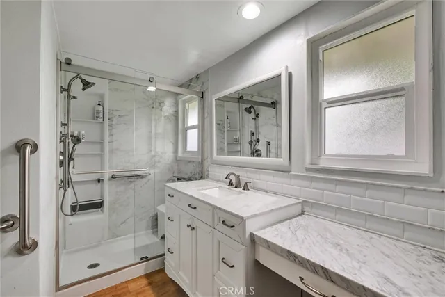 a bathroom with a granite countertop sink mirror and double