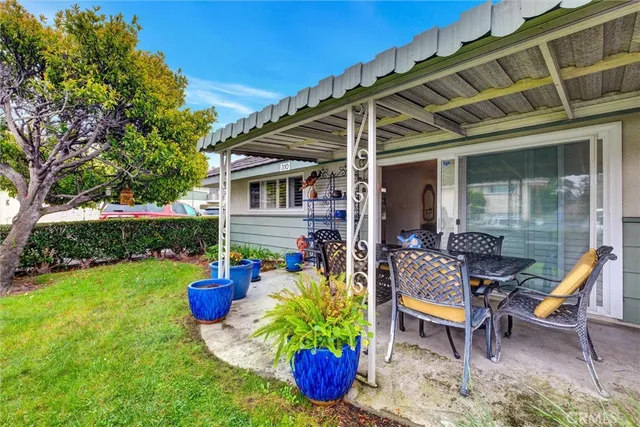 a backyard of a house with outdoor seating