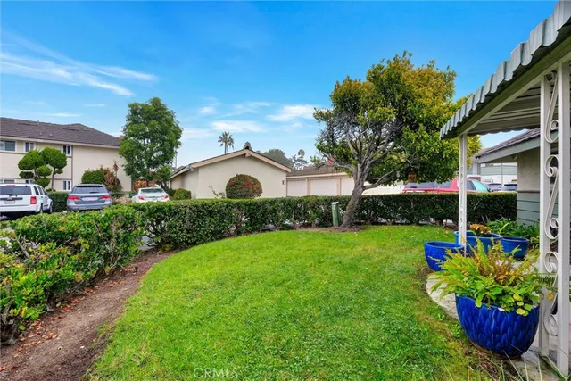 a view of a backyard with plants and a patio
