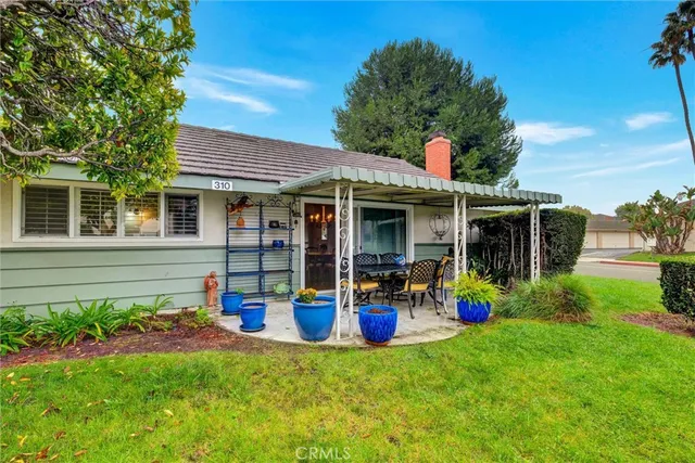 a front view of house with yard and outdoor seating