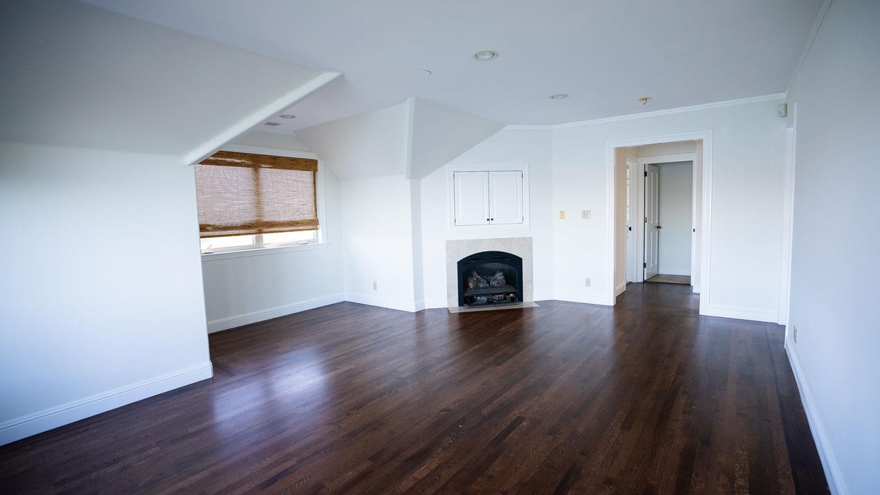 189 Kent Road Pacifica, CA 94044 - Photo 10 of 15 an empty room with wooden floor and a fireplace