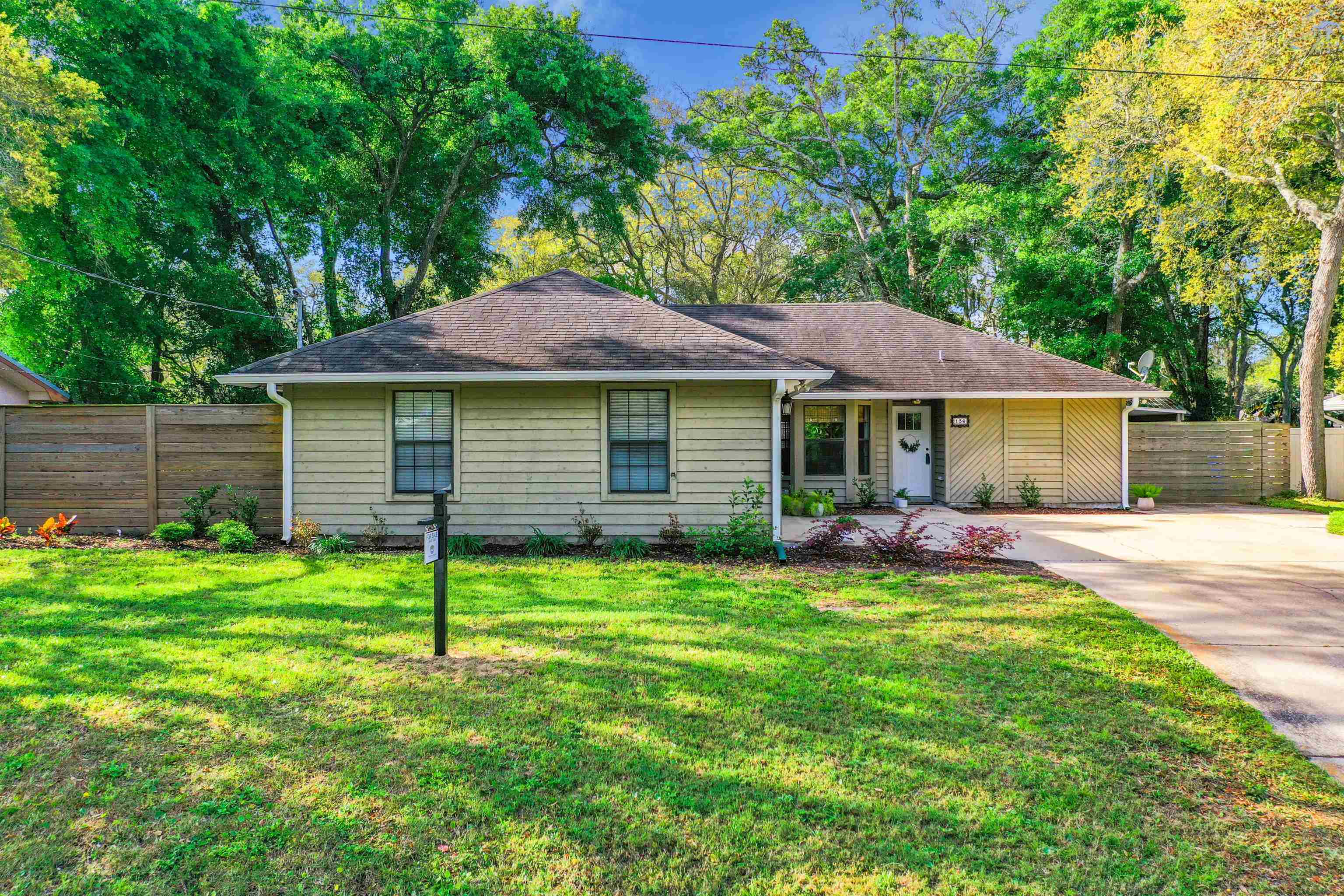 136 Pelican Road St. Augustine, FL 32086 - Photo 1 of 45 a front view of a house with a garden