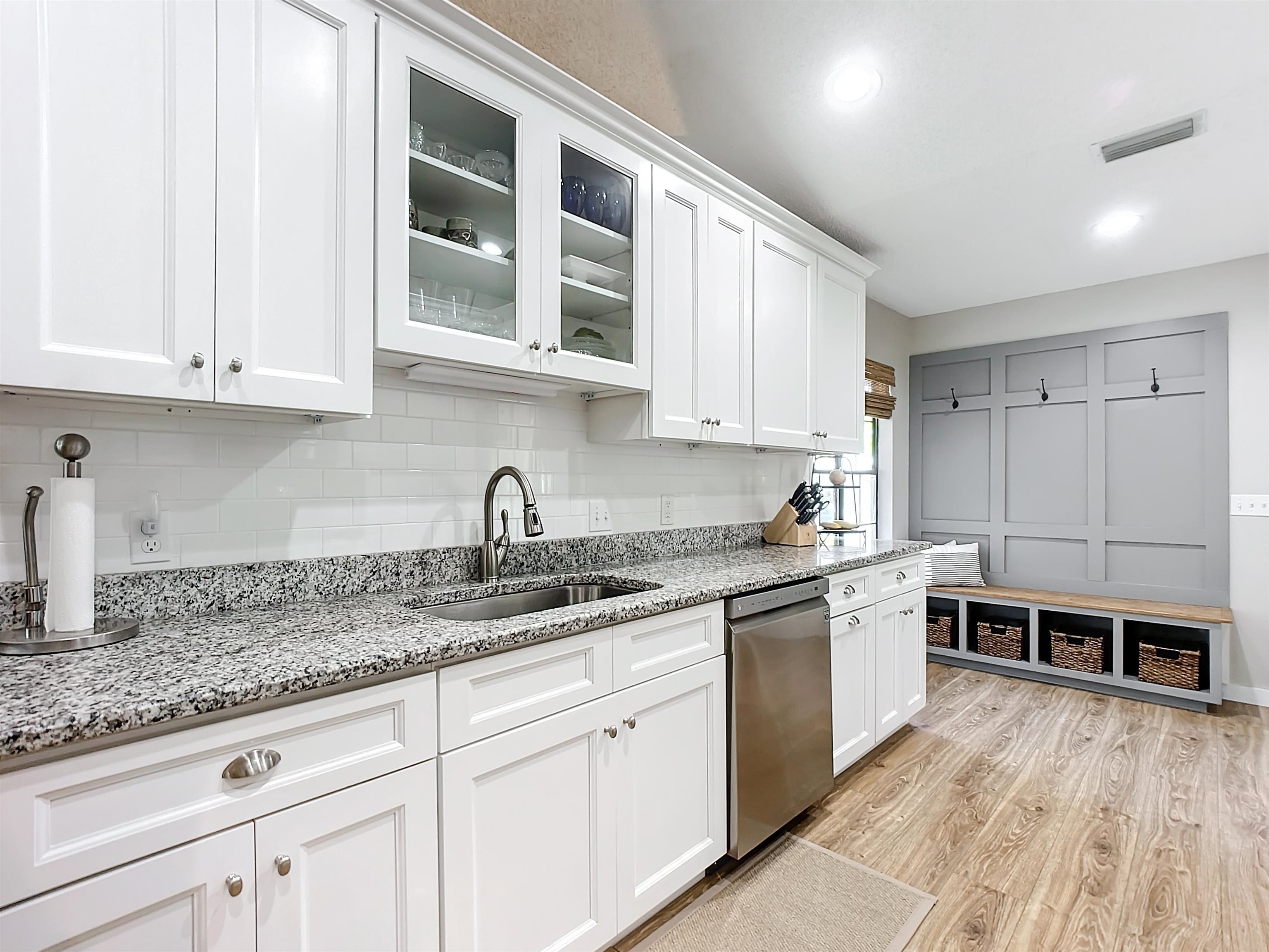136 Pelican Road St. Augustine, FL 32086 - Photo 17 of 45 a kitchen with stainless steel appliances granite countertop a sink and cabinets with wooden floors