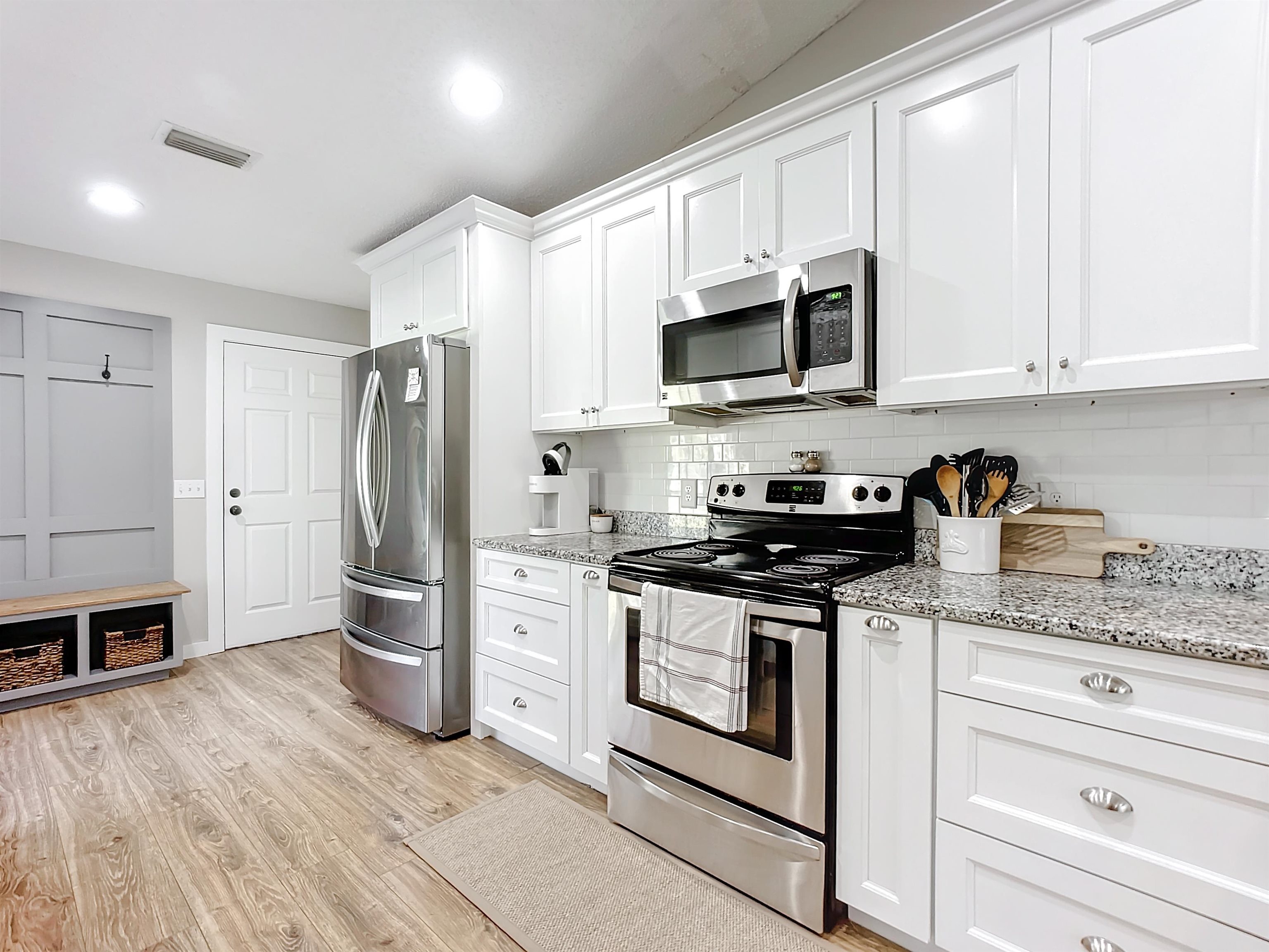136 Pelican Road St. Augustine, FL 32086 - Photo 18 of 45 a kitchen with stainless steel appliances granite countertop a refrigerator stove and white cabinets