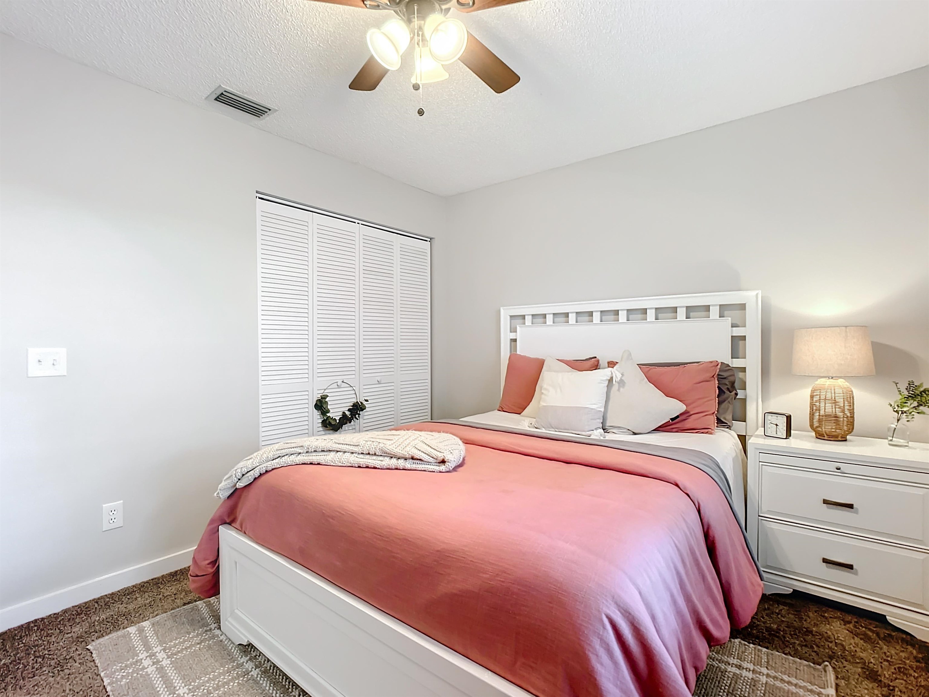 136 Pelican Road St. Augustine, FL 32086 - Photo 28 of 45 a bedroom with a bed and a chandelier