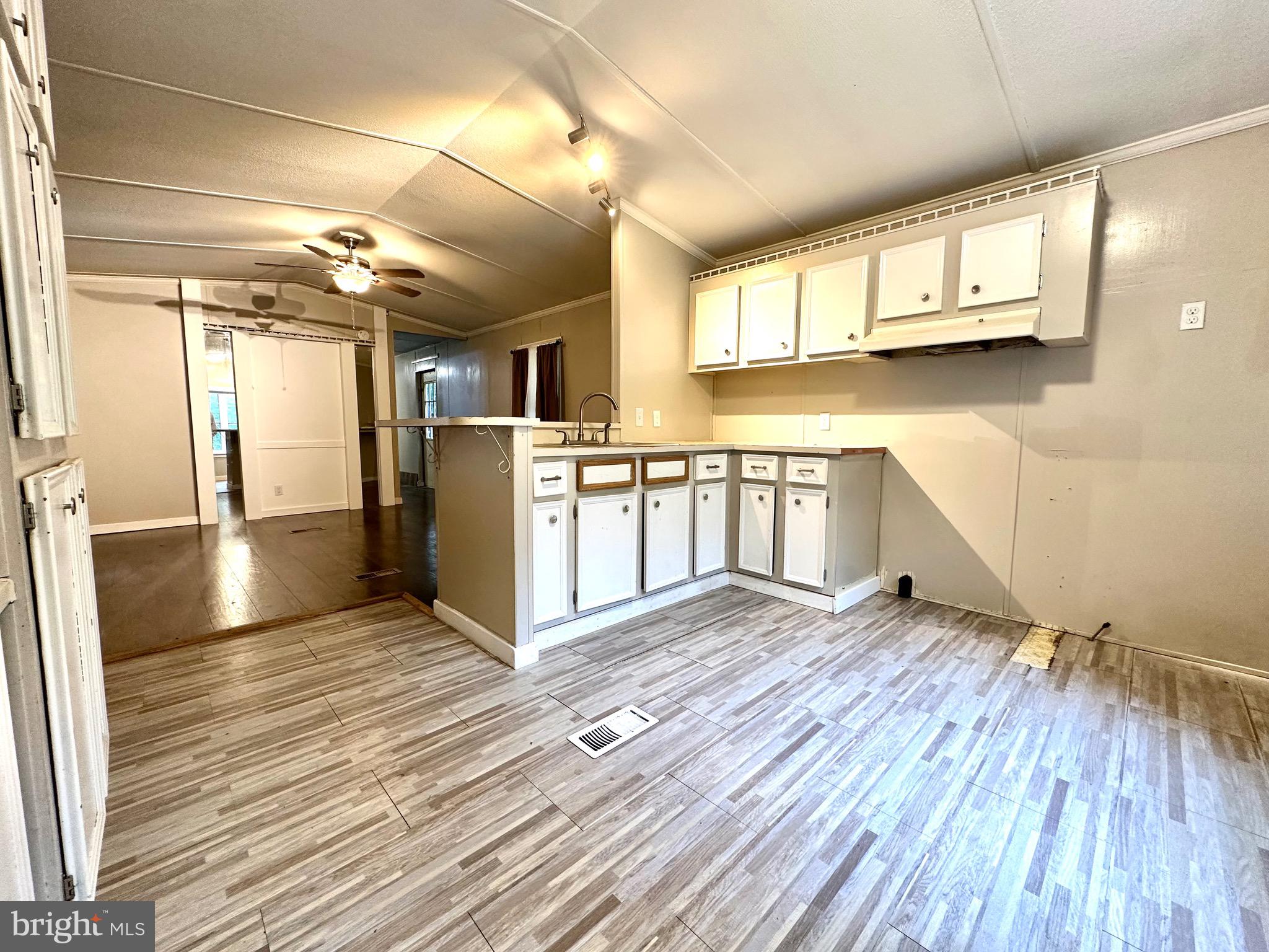 606 Dogwood Acres Road Bumpass, VA 23024 - Photo 5 of 20 a view of a kitchen with furniture and wooden floor
