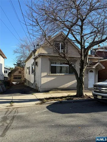 a view of a house with snow on the road