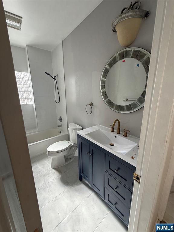 16 Corabelle Avenue Lodi, NJ 07644 - Photo 12 of 20 a bathroom with a toilet a sink and mirror
