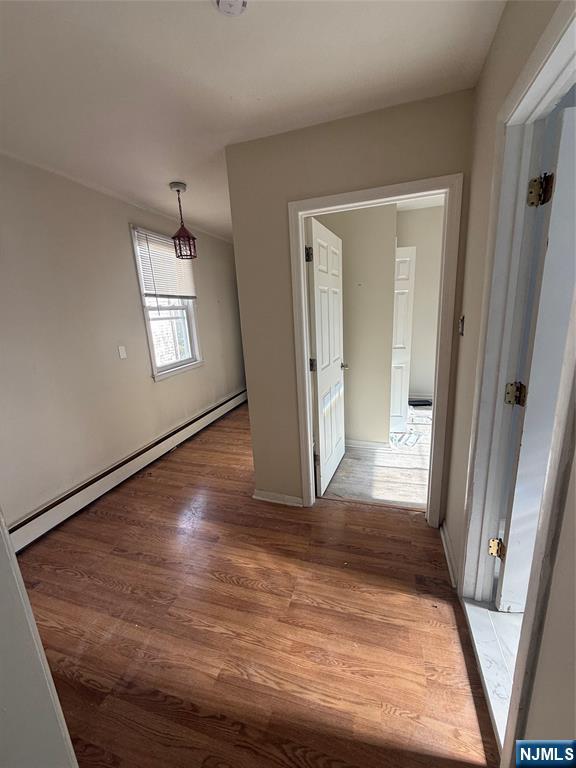 16 Corabelle Avenue Lodi, NJ 07644 - Photo 14 of 20 an empty room with wooden floor and windows