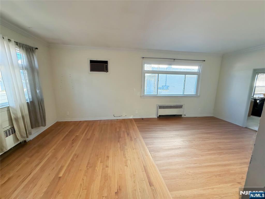16 Corabelle Avenue Lodi, NJ 07644 - Photo 7 of 20 a view of empty room with wooden floor and fan