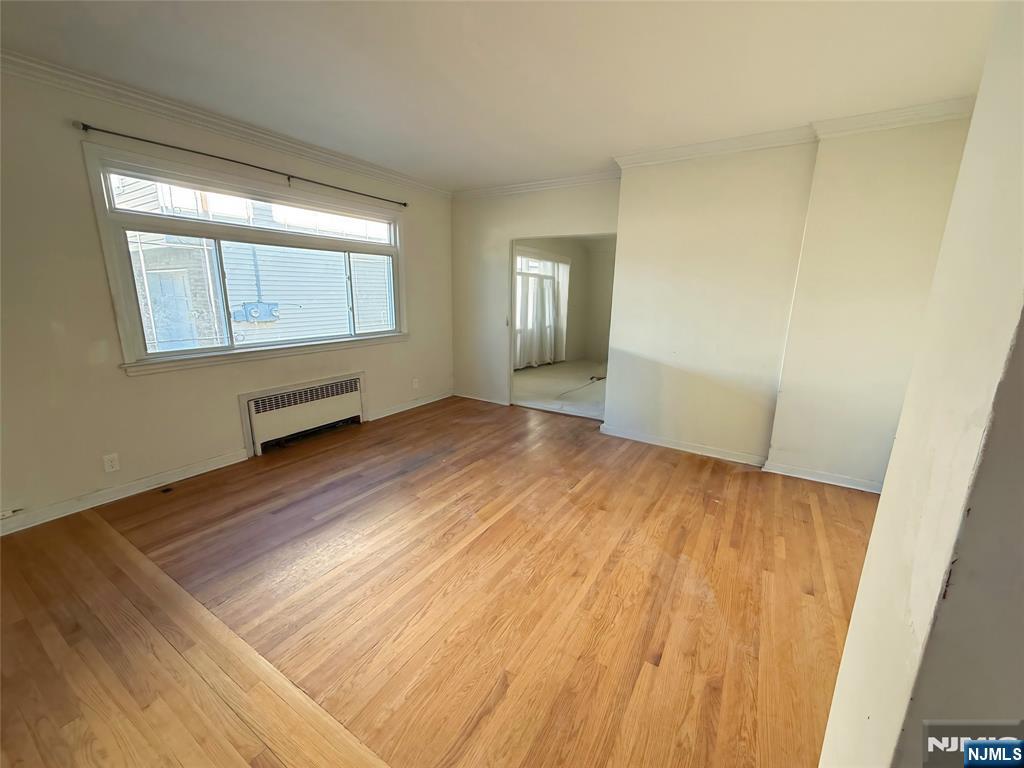 16 Corabelle Avenue Lodi, NJ 07644 - Photo 8 of 20 an empty room with wooden floor and windows