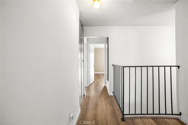 a view of an empty room and wooden floor