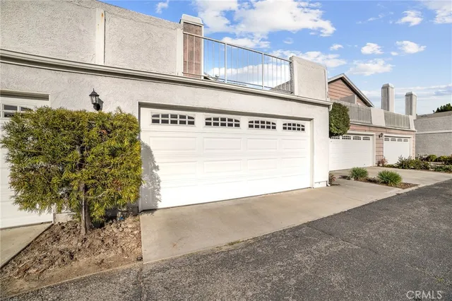 an aerial view of residential houses with outdoor space and parking
