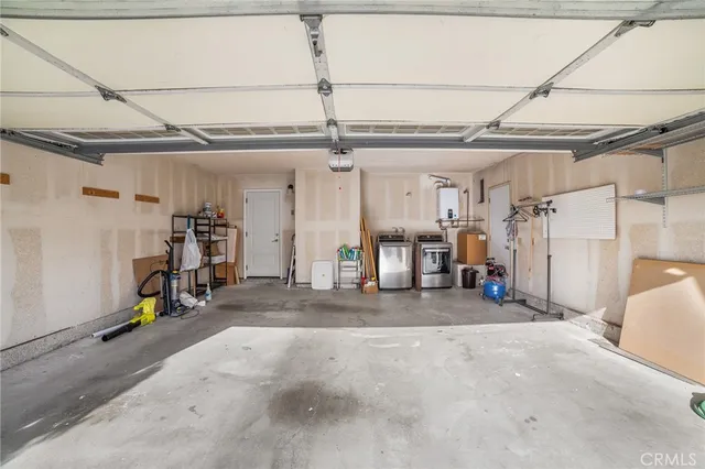 an aerial view of residential houses with outdoor space and parking