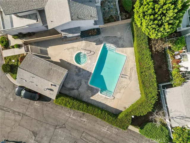 an aerial view of residential houses with outdoor space and trees