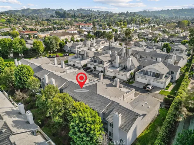 an aerial view of a house with a garden and lake view