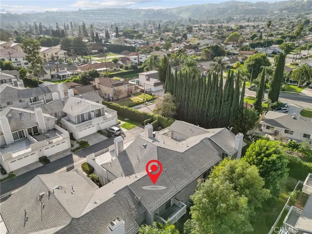 an aerial view of residential houses with outdoor space and parking