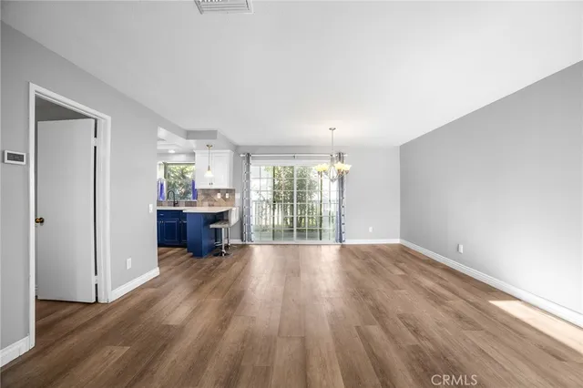 a view of an empty room with window and fire place