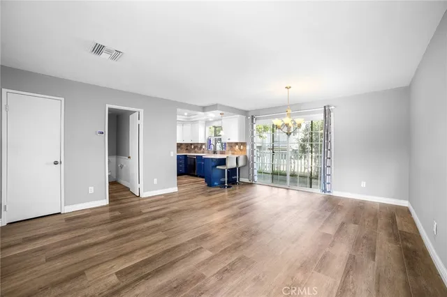 a view of an empty room with a window and fireplace